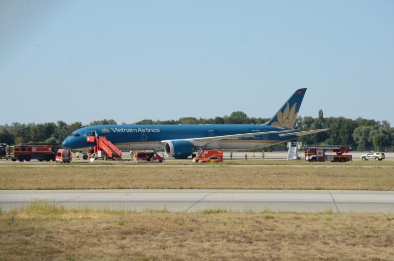 Vietnam Airlines Boeing 787 Suffers Tailstrike After Extended Takeoff Run At Munich SEO DES: The crew climbed to 9,000 feet and remained near Munich for two hours; Returned after tail-contact and low-tyre-pressure warnings, with damage SOCIAL: A Vietnam Airlines Boeing 787-9 flying from Munich to Hanoi took an unusually long takeoff roll on Runway 26L on August 15, 2026, before becoming airborne near the runway end. The aircraft reportedly travelled about 120 metres beyond the paved surface, with a tailstrike occurring during the late rotation. After takeoff, the crew climbed to around 9,000 feet and remained near Munich for about two hours before returning to the airport after warnings for tail contact and low tyre pressure. The aircraft sustained tail, landing-gear and tyre damage and could not taxi away after landing. The aircraft carried 271 passengers and 16 crew, all of whom were reported safe with no injuries. German authorities are leading the investigation, with Vietnamese investigators assisting, while the exact cause of the prolonged takeoff remains under investigation. Munich, Germany: A Vietnam Airlines Boeing 787-9 bound for Hanoi took an unusually long takeoff run from Munich Airport on August 15 before finally becoming airborne beyond the normal paved runway area, in an incident that resulted in runway damage, a tail strike and subsequent damage to the aircraft's landing gear. The aircraft later returned to Munich after remaining airborne for about two hours, with no injuries reported among the passengers or crew. The exact reason for the aircraft's prolonged acceleration and extremely late liftoff remains under investigation. The most significant part of the incident occurred during the takeoff roll. Video footage recorded from inside the cabin and from outside the airport shows the 787 accelerating along Runway 26L for an unusually long distance before rotation. Instead of lifting off with substantial runway remaining, the aircraft continued almost to the end of the approximately 4,000-metre runway. Reports based on flight-tracking data indicate that the aircraft reached the runway end area before becoming airborne, with reports putting the excursion beyond the paved surface at roughly 120 metres. The available video is particularly significant because it shows that the issue was not simply a conventional tailstrike during an otherwise normal rotation. The aircraft appears to remain on the ground for an unusually long period, with the runway threshold passing while the aircraft was still accelerating. It eventually rotated at the very end of the runway area, after which a large cloud of dust was visible beneath the rear of the aircraft. The reason for the unusually slow or prolonged takeoff has not been established. Online speculation has included possibilities such as an incorrect takeoff configuration, incorrect thrust or a problem affecting the aircraft's acceleration. However, none of those explanations has been confirmed by Vietnam Airlines or investigators and should not be presented as the cause. Vietnam Airlines has described the event as resulting from a technical issue and said the crew followed safety procedures. The airline has not publicly identified a specific technical failure responsible for the aircraft's unusually long takeoff roll. That distinction is important because the aircraft's subsequent warnings and damage do not, by themselves, establish what caused the initial lack of acceleration. Vietnam's aviation authorities have provided additional information on what happened after the aircraft became airborne. According to the latest reporting on the Civil Aviation Authority of Vietnam's information, warnings indicating tail contact and low tyre pressure were triggered shortly after takeoff. The authorities said the aircraft subsequently returned to Munich, while German authorities led the investigation with Vietnamese investigators assisting. After the aircraft finally lifted off, the crew did not immediately attempt to land. The Boeing 787 climbed to around 9,000 feet and remained in the Munich area for approximately two hours. During that period, the crew assessed the situation and reduced the aircraft's weight before returning to the airport. The tailstrike occurred as the aircraft became airborne after the exceptionally long takeoff run. The rear underside of the aircraft contacted the ground, producing the visible dust plume captured on video. A tailstrike can damage the aircraft's lower aft fuselage, pressure vessel, structural frames, systems, wiring and other components around the tail area. In this case, photographs and video circulating after the incident showed damage around the rear fuselage and the loss or damage of the Boeing 787's tailstrike protection component. The full extent of the structural damage, however, remains subject to technical inspection. The aircraft also sustained landing-gear and tyre damage. Reports indicate that several tyres were damaged or deflated, and footage following the return showed the aircraft unable to taxi away from the runway under its own power. The landing-gear damage also resulted in debris being left on the runway. The aircraft eventually landed back at Munich Airport, using the airport's other runway. Following the landing, the affected aircraft remained on the runway, forcing the closure of the runway and requiring airport authorities to clear debris and deal with the disabled aircraft. Traffic was subsequently handled through the other available runway, causing disruption at the German hub. There were no reported injuries among the passengers or crew. The aircraft was carrying passengers and crew on the Munich-Hanoi service; Vietnam Airlines has reported the total as 271 passengers and 16 crew members. All occupants were reported safe after the aircraft returned to Munich. The incident is now being examined by the relevant German authorities, with Vietnamese aviation investigators assisting. Investigators will need to establish why the Boeing 787 did not achieve the expected acceleration during the takeoff roll, why the aircraft reached the end of the runway area before becoming airborne and whether any technical, operational or performance-related factor contributed to the event.