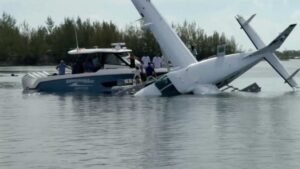 Bimini, The Bahamas: A Tropic Ocean Airways seaplane carrying eight American passengers and two crew members crashed into the water while preparing for departure from North Bimini, Bahamas, on August 1, with all 10 occupants rescued safely in an incident that is now under investigation by Bahamian authorities. According to the Royal Bahamas Police Force, the Cessna 208B Grand Caravan seaplane was departing from North Bimini for Fort Lauderdale, Florida, when the accident occurred shortly before takeoff. Police said the aircraft was taxiing on the water and attempting to line up for departure when it reportedly veered uncontrollably to the left. The pilot is said to have taken evasive action to avoid heavy boat traffic in the area, but the aircraft struck a dock before overturning and sinking in waters estimated to be about 100 feet (30 metres) deep. The aircraft was operated by Tropic Ocean Airways, a Florida-based seaplane carrier that provides scheduled and charter flights between South Florida, the Bahamas and other Caribbean destinations. The airline confirmed the aircraft was involved in an accident and said it is cooperating fully with the ongoing investigation. All eight passengers, identified only as American tourists, along with the two crew members, escaped the aircraft and were rescued safely. Nick Pavlakis, general manager of Marine Max in Jupiter and a rescue boat operator, witnessed the crash and quickly took action to help the eight passengers and two crew members on board. Authorities have not released the identities of the passengers or crew, and no injuries have been officially reported. The rescue began almost immediately as nearby boaters, marina personnel and bystanders rushed to assist those aboard. Witnesses helped evacuate the occupants from the overturned aircraft before emergency responders arrived at the scene. The Royal Bahamas Police Force later confirmed that everyone on board had been accounted for and rescued. Passenger Jeanne O'Brien, who was among those on board, told ABC News that the aircraft "went down pretty fast" after striking the dock. She said the passengers worked together to exit the cabin after the impact. Video recorded following the accident showed occupants in the water wearing life jackets as nearby vessels converged to assist. ABC News reported that the rescue was completed within minutes. Authorities have not determined the cause of the accident. Investigators are expected to examine the aircraft, pilot actions, operating conditions and other factors to establish why the seaplane lost directional control while taxiing for departure. No mechanical failure has been confirmed, and officials have not indicated whether weather or water conditions contributed to the accident. The Royal Bahamas Police Force is leading the initial investigation, while additional aviation authorities are expected to review the occurrence in accordance with international accident investigation procedures. Tropic Ocean Airways said it is providing full assistance to investigators and remains focused on supporting those affected. The accident resulted in substantial damage to the aircraft, which came to rest submerged after overturning. Recovery operations are expected to support the investigation into the sequence of events leading up to the crash. Further updates are expected once Bahamian investigators release additional findings or a preliminary accident report.