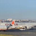 Sydney, Australia: A Jetstar Airbus A320 and a Qatar Airways Boeing 777 came dangerously close to a collision while moving on the ground at Sydney Airport on Sunday morning, August 9, after the Jetstar crew was forced to brake abruptly to avoid the Qatar aircraft. The incident occurred at about 7:00am local time at Sydney Kingsford Smith Airport. The Jetstar A320, operating flight JQ402 from Sydney to Gold Coast Airport, was taxiing for departure when its crew observed the Qatar Airways Boeing 777 being towed by an aircraft tug on a crossing taxiway. The ATSB said both aircraft were brought to an abrupt stop, preventing a collision. According to Australian media reports, the Jetstar aircraft stopped about 50 metres from the Qatar 777. The sudden braking caused a rear cabin crew member aboard the Jetstar aircraft to fall and suffer a broken wrist. No Jetstar passengers were injured. JQ402 was carrying 151 passengers and six crew members, according to Australian media reports. The flight was subsequently cancelled and passengers were rebooked onto later services. The Qatar Boeing 777 was not operating a passenger departure at the time. It had arrived at Sydney from Doha and was being repositioned under tow after passengers had disembarked. The aircraft therefore had no passengers onboard during the near-collision. The precise sequence that brought the two aircraft into such close proximity remains under investigation. Jetstar said its aircraft was following air traffic control instructions when its pilots were forced to brake firmly after another aircraft came into close proximity. The airline has also begun its own investigation. The ATSB said there was damage to the connection between the Qatar 777's nose landing gear and the aircraft tug. Investigators will examine data from both aircraft and air traffic control, while interviewing the flight crew, tug operators, air traffic controllers and other witnesses. CCTV and other recorded information will also be reviewed. ATSB Chief Commissioner Angus Mitchell said it was too early to determine where the communication or coordination breakdown occurred. Investigators will establish what instructions were issued, how they were understood and why the aircraft came so close before the final stop. The incident has also drawn attention to air traffic-control staffing pressures at Sydney Airport. ABC reported that air traffic control was operating under restrictions between 6:00am and 8:00am on Sunday, limiting the number of aircraft moving through the airport. More than 150 flights had also been affected by roster constraints in the days leading up to the incident. However, there is currently no official finding that the staffing situation caused the near-collision. The ATSB investigation will determine whether communication, coordination, ground movements, procedures or other factors contributed. Two people involved in the ground operation, an air traffic ground controller and the tug operator were stood down for mandatory drug and alcohol testing, which the federal transport minister described as standard post-incident procedure. Their stand-down should not be interpreted as a finding of fault. The ATSB has asked anyone with video of Sunday's incident or its immediate aftermath to provide footage to investigators. The investigation remains ongoing.