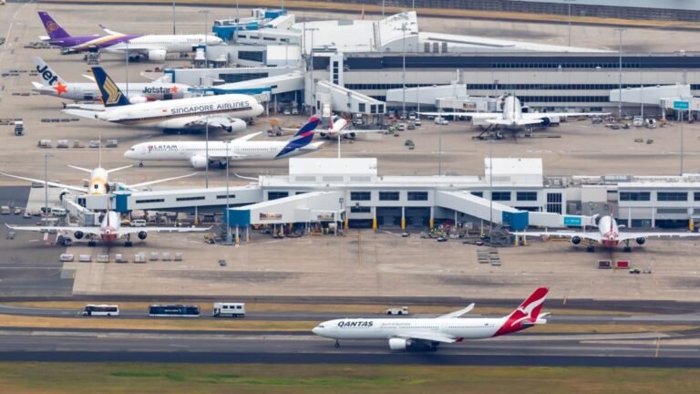 Sydney, Australia: The Australian Transport Safety Bureau (ATSB) on Friday, August 21, 2026, confirmed an investigation into a fourth ground-safety incident at Sydney Airport within just over three weeks, involving two Qantas aircraft that received potentially conflicting taxi instructions on August 18. The investigation, AO-2026-091, concerns an Airbus A321, registration VH-OGA, operating Qantas Flight QF405 to Melbourne, and a Boeing 737-838, registration VH-VXL, operating Qantas Flight QF589 from the Gold Coast. The ATSB's latest announcement said investigators will interview the air traffic controllers and flight crews involved, examine recorded data and collect other relevant evidence. The agency has not yet determined a cause or contributing factor and said a final report will be released after the investigation is completed. The August 18 event occurred at about 8:09 a.m. Australian Eastern Standard Time. After landing on Runway 34R, Qantas Boeing 737-838, QF589 taxied west on Taxiway Lima with clearance to turn right at Taxiway Bravo. At the same time, Qantas Airbus A321-271NY, QF405 was taxiing south on Taxiway Charlie after being cleared to turn right onto Taxiway Lima. As the A321 approached the taxiway, its crew saw the Boeing 737 approaching from the left and stopped the aircraft, allowing the 737 to pass. The ATSB classified the occurrence as an incident, with the aviation occurrence categories listed as failure to pass traffic and information/procedural error. There were no injuries or aircraft damage. The ATSB said there was “no immediate risk of collision” because QF405 braked normally before stopping. It nevertheless opened an investigation to understand the potential conflicting instructions given to the two crews. Airservices Australia said it reported the potential traffic conflict to safety authorities on Tuesday, August 18, and Qantas said its aircraft had been cleared to proceed in accordance with air traffic control instructions and that it would support the investigation. The latest event is the fourth Sydney Airport safety incident being investigated by the ATSB since July 27. Importantly, the ATSB has not found a common cause or fault in any of the four incidents at this stage. All four investigations remain active or pending, meaning claims that staffing shortages, training problems or the new Sydney Basin airspace changes caused the incidents would go beyond what the safety bureau has established so far. Airservices Australia has said the incidents involve different circumstances and that each is being examined on its individual facts. The first incident occurred on July 27, 2026, and is recorded by the ATSB as AO-2026-086 “Breakdown of coordination involving Bombardier DHC-8, VH-QOC, and Boeing 737, VH-XZG, at Sydney Airport.” The occurrence took place at 8:14 a.m. AEST and involved QantasLink Flight QLK424D, travelling from Canberra to Sydney, and Qantas Flight QFA124, travelling from Queenstown, New Zealand, to Sydney. ATC cleared the Boeing 737 to cross Runway 34L from Runway 25 while the QantasLink DHC-8 was still in its landing roll on Runway 34L. Controllers detected the developing conflict and alerted both crews, after which the 737 stopped beyond the runway holding point. The ATSB has classified the investigation as an active short occurrence investigation, with completion anticipated in Q4 2026. The second incident occurred on August 9 at about 7:20 a.m. and involved Jetstar Flight JQ402, an Airbus A320-232 registered VH-VQJ, and a Qatar Airways Boeing 777-300ER, registered A7-BEU, which was being towed by a tug. The ATSB's investigation number is AO-2026-087, titled “Taxiing proximity event involving Airbus A320-232, VH-VQJ and Boeing 777, A7-BEU, at Sydney Airport.” As the Jetstar aircraft taxied before departure for the Gold Coast, its crew saw the Qatar 777 in close proximity on a crossing taxiway. Both aircraft stopped abruptly, and a Jetstar cabin crew member was reported to have suffered a minor injury. No aircraft damage was reported. The incident triggered immediate scrutiny of ground operations. The Australian Transport Minister, Catherine King, said a ground controller and the tug operator were stood down for mandatory drug and alcohol testing, describing it as standard policy while the ATSB investigation was under way. “As is policy, the ground controller and tug operator have been stood down for mandatory drug & alcohol testing,” the minister's statement said. No passengers were injured, while the Jetstar crew member was assessed by paramedics. Only about three hours later, on the morning of August 9, Sydney Airport recorded its third incident in the sequence. The ATSB investigation, AO-2026-090, is titled “Runway incursion and rejected take-off involving Boeing 737-8SA, VH-IJQ, and Boeing 737-838, VH-XZH.” The aircraft were Virgin Australia Flight VA555, scheduled from Sydney to Perth, and Qantas Flight QF728, scheduled from Sydney to Ayers Rock Airport. At around 10 a.m., ATC cleared the Virgin Australia 737, registered VH-IJQ, for a full-length departure from Runway 34L. As the Virgin crew applied thrust, they saw the Qantas 737, registered VH-XZH, begin crossing the runway from Taxiway Lima. The Qantas crew reported that it had also received clearance from ATC to cross. The Virgin crew reduced thrust and stopped on the runway, while ATC simultaneously cancelled the take-off clearance. After the Qantas aircraft cleared the runway, the Virgin 737 was cleared to depart. The ATSB classified the occurrence as an incident involving information/procedural error, loss of separation, rejected take-off and runway incursion. No injuries or aircraft damage were recorded. The four incidents have also intensified scrutiny of Sydney's air traffic-control workforce and the major airspace changes introduced ahead of the opening of Western Sydney International Airport. CASA implemented the new Sydney Basin airspace arrangements on July 9, creating new controlled airspace around Western Sydney International and changing the structure around Sydney Kingsford Smith, Bankstown and Camden airports. CASA said the changes were designed to integrate the airports while maintaining capacity, efficiency and aircraft separation. Reuters reported that the ATSB had received a June report from an air traffic controller warning that staff at Sydney Airport were not adequately prepared for complex airspace and procedural changes linked to the opening of Western Sydney International Airport. The report cited concerns over limited training time and the volume of new material. CASA later found that Airservices Australia had implemented appropriate training, procedures and operational support arrangements. The sequence has also prompted warnings from aviation safety specialists. Retired commercial pilot and former ATSB safety investigator Geoff Klouth said the repeated events should be addressed quickly. “We've been very fortunate that there haven't been collisions, but it doesn't mean it won't happen in the future,” he said, warning that the consequences of a future failure could be catastrophic. For now, however, the official position remains that there is no established common cause behind the four incidents. The ATSB is examining each occurrence separately while also looking for common contributing factors. The July 27 coordination breakdown, the August 9 Jetstar-Qatar taxiing event, the August 9 Virgin-Qantas runway incursion and rejected take-off, and the August 18 Qantas taxiing conflict are all still under investigation. Until the ATSB releases its findings, staffing shortages, training pressures, airspace redesign and procedural errors should be treated as areas of concern or investigation rather than confirmed causes.