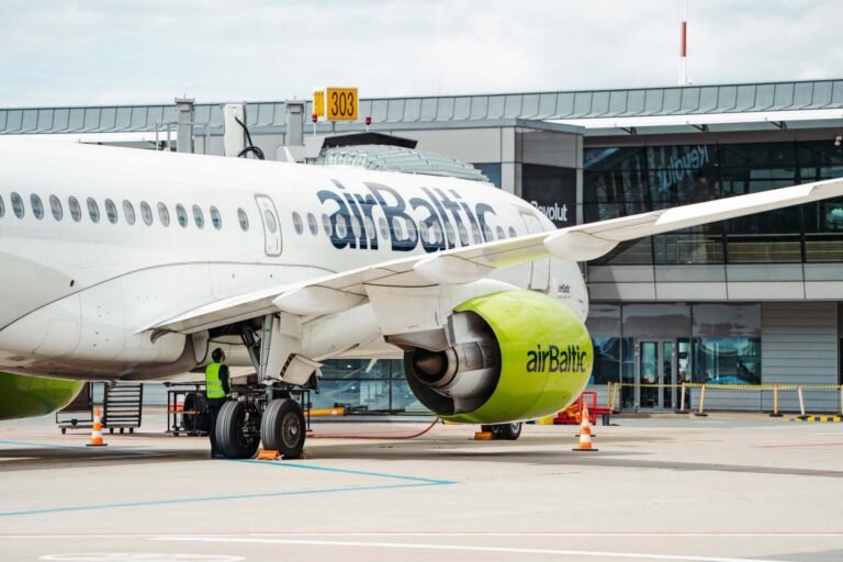 New York, United States: Latvia’s national airline airBaltic voluntarily filed for protection under Chapter 11 of the US Bankruptcy Code in New York on 14 September 2026, seeking to restructure its debt after soaring jet fuel costs and stalled negotiations with creditors pushed the carrier into acute financial stress. The airline said it had secured a commitment for €350 million ($405 million) in financing from Strategic Value Partners, Barclays, Hayfin Capital Management, Morgan Stanley and Oaktree Capital Management to support operations during the restructuring. The financing carries an interest rate of about 12% and remains subject to court approval. AirBaltic said it expects the court-supervised restructuring to be completed by June 2027, while flights will continue as scheduled. The filing comes as the aviation industry faces severe pressure from the Iran war that has doubled jet fuel prices and triggered the sector’s worst crisis since the COVID-19 pandemic. AirBaltic’s board said in a bankruptcy-court filing that the airline was experiencing “acute financial stress due to a combination of financial and geopolitical factors.” AirBaltic had been negotiating with creditors to secure additional financing, but the talks failed to produce an agreement. Before the bankruptcy filing, bondholders were due to vote on a proposal to raise up to €257 million through new super-senior debt due in February 2027, carrying an interest rate of 25%. Latvian Prime Minister Andris Kulbergs said bondholders representing more than 70% of the value of the airline’s debt chose liquidation instead of approving the financing required to keep the company going. “I view this solution as one of the best options for ensuring airBaltic’s viability, as it provides the necessary tools and time to implement the restructuring plan,” Kulbergs said. The Latvian government is continuing to search for a strategic investor while airBaltic reduces its fleet and reorganises its financial obligations. AirBaltic’s financial problems had been building before the latest fuel shock. The airline said it had about $583 million in funded debt and finance lease liabilities, while it owed €106 million in payroll taxes, airline taxes and fees. The carrier generated about €779 million in revenue in 2025. Kulbergs said airBaltic had “burned through” €380 million raised through bonds issued in 2024 by April 2026. A €30 million emergency government loan provided to the airline ran out in June. The airline had also attempted to lease out excess aircraft as it sought ways to improve its financial position. AirBaltic had previously planned to expand its fleet to 100 aircraft. However, the company’s growth strategy was hit by the loss of potential transit traffic from Russia, Belarus and Ukraine through Riga, while higher fuel costs made its financial position more difficult to sustain. Aviation analyst Simonas Bartkus said, “This is no longer available, and the company became too large for its market. The rise in fuel costs made the situation acute, they had no time to find a solution.” Kulbergs said, “Serving Baltic and Latvian routes requires only 30 aircraft, not 100.” AirBaltic currently operates about 50 Airbus A220-300 aircraft. As part of the Chapter 11 process, the airline plans to cancel or defer outstanding deliveries from a $3.5 billion order for 40 additional Airbus aircraft. It also plans to address $106.7 million worth of additional aircraft engines ordered from Pratt & Whitney. AirBaltic said it had already begun discussions with Airbus about deferring additional aircraft deliveries beyond 2026. Airbus did not immediately respond to Reuters’ request for comment, while RTX, the parent company of Pratt & Whitney, declined to comment. AirBaltic employs more than 3,000 people and has been expanding its global workforce for about a decade. CEO Erno Hilden said the airline was in talks with labour unions about “an adjustment in the workforce”, which he described as a natural consequence of the carrier’s existing capacity-reduction plans. Hilden said the largest operational changes during the Chapter 11 restructuring would involve reducing airBaltic’s wet-lease business, under which the airline provides aircraft and crews to other carriers for a fee. Despite the financial difficulties, Hilden said he remained confident about the underlying business. “I do think that the underlying business for airBaltic is a very healthy one. So after we really execute on our new business plan, I do see a bright future for the company,” he said. AirBaltic said the Chapter 11 filing is intended to provide protection from creditors while it negotiates a restructuring of its debt. The airline has said its flights will continue to operate as scheduled throughout the court-supervised process. The restructuring is expected to be completed by June 2027. Hilden, who previously led Scandinavian airline SAS through its own Chapter 11 restructuring between 2022 and 2024, said airBaltic is “targeting the same process”. The Latvian government remains the majority owner of airBaltic, while Germany’s Lufthansa holds a 10% minority stake. The government is continuing to seek a strategic investor as the airline restructures its debt, reduces its fleet and adjusts its operations. AirBaltic’s Chapter 11 filing makes it the second airline casualty linked to the economic impact of the Iran war after Spirit Airlines, although Spirit had entered bankruptcy months before the conflict began. The immediate challenge for airBaltic is to stabilize its finances while maintaining its network and operations. The airline now has until the planned completion of the Chapter 11 process in June 2027 to implement its restructuring plan, reduce costs and establish a more sustainable financial structure.