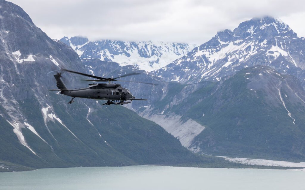 Alaska, United States: Four people were rescued after a Cessna 180 crashed and overturned on a coastal sandbar on Alaska’s Montague Island on August 30, 2026 with Alaska Air National Guard personnel responding to the remote site and transporting all four occupants to a hospital in Anchorage. The crash occurred on a coastal sandbar on Montague Island, about 60 miles southeast of Seward, Alaska, according to the Alaska National Guard. The aircraft was identified as a Cessna 180 carrying four people. The official report did not release the occupants’ names, the aircraft’s registration, the exact flight route or a specific cause of the crash. The rescue operation began after the Alaska Rescue Coordination Center (AKRCC) at Joint Base Elmendorf-Richardson received a signal from the aircraft’s 406 MHz emergency locator transmitter (ELT). The ELT was registered to the owner of the Cessna 180, allowing authorities to identify the aircraft associated with the emergency signal. The people involved in the incident also had a consumer-grade two-way satellite communication device. According to the Alaska National Guard, the device helped maintain the flow of information with the AKRCC and assisted rescuers in obtaining a more precise location of the crash site. Following the alert, the AKRCC requested assistance from the Alaska Air National Guard’s 176th Wing search-and-rescue duty officer. A HH-60W Jolly Green II helicopter from the 210th Rescue Squadron was dispatched with pararescuemen from the 212th Rescue Squadron, commonly known as PJs, aboard. When the rescue team reached the crash site, the Cessna had overturned. Despite its position, the aircraft appeared to be seemingly undamaged, and the four occupants had managed to get themselves out before the pararescuemen reached them. The rescue operation required additional caution because the aircraft had come down on a coastal sandbar. Flying sand and beach debris posed a hazard to the helicopter, so the HH-60W crew landed at a safe distance from the crash site rather than directly next to the occupants. The pararescuemen then made contact with the four people and assessed their condition. One occupant had suffered a back injury. The PJs stabilized the injured person using a vacuum splint and cervical collar before securing the occupant in a Stokes litter for helicopter transportation. The HH-60W crew subsequently flew the injured occupant and the other three people to Providence Alaska Medical Center in Anchorage. They were handed over to civilian medical personnel at the hospital. The Alaska National Guard said the incident also demonstrated the importance of reliable emergency-location and communication equipment during aircraft emergencies in remote areas. AKRCC officials urged aircraft owners to keep their 406 MHz ELT registrations current and encouraged pilots to carry an additional satellite communication device to help speed up rescue operations. The Alaska National Guard reported that all four occupants were rescued from the crash site and transported for medical care. The agency did not provide further information on the occupants’ identities or disclose what caused the Cessna 180 to crash.