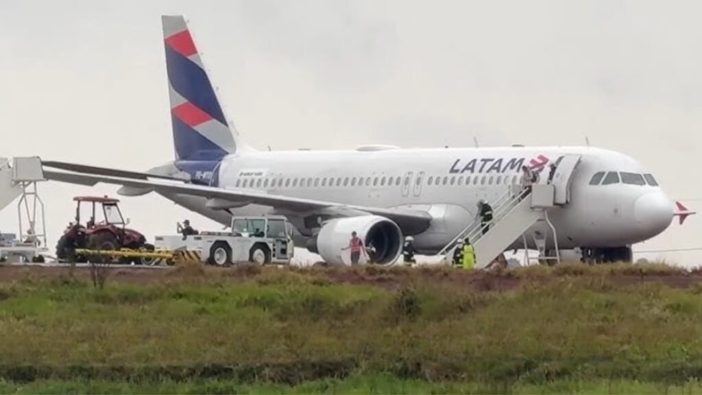Cascavel, Brazil: A LATAM Airlines Brasil Airbus A320 carrying 151 people left the paved runway while landing at Cascavel Regional Airport in Paraná, Brazil, on August 31, 2026. The aircraft, operating flight LA3858 from São Paulo–Guarulhos International Airport to Cascavel, came to rest on soft, rain-soaked ground beside the runway. All 145 passengers and six crew members were evacuated safely, with no injuries reported. Flight LA3858 departed São Paulo-Guarulhos International Airport and was scheduled to arrive at Cascavel, approximately 710 km west of Curitiba. Flightradar24 data shows PR-MYO departed Guarulhos at about 11:19 UTC and landed at Cascavel at approximately 12:47 UTC, corresponding to about 9:47 a.m. local time. LATAM placed the occurrence at approximately 9:45 a.m. local time. The incident occurred amid rain, thunderstorms and reduced visibility around Cascavel. Weather observations for the airport recorded thunderstorms and rain in the period surrounding the aircraft's arrival, with visibility at one point reduced to about 3,000 metres. Other reports noted heavy rain and standing water around the runway area. According to tracking-based reports, the aircraft landed on Runway 15 and decelerated normally. It slowed to approximately 15 knots before the crew began a turn to backtrack along the runway. During that low-speed maneuver, the A320 departed the paved surface and entered the soft ground beside the runway, where its landing gear became partially embedded in mud. LATAM itself described the occurrence more broadly as the aircraft exceeding the runway limit during the final stage of landing. The airline has not publicly confirmed that aquaplaning, inadequate braking, runway contamination or any other specific factor caused the aircraft to leave the pavement. Although the heavy rain and wet surface are relevant circumstances, the available reports do not establish them as the confirmed cause. The airline said in its statement: “LATAM Airlines Brasil reports that the aircraft operating flight LA3858 (Guarulhos–Cascavel) on Monday (August 31) exceeded the runway limit during the final stage of its landing at approximately 9:45 a.m. local time. All 145 passengers and six crew members disembarked safely, and there were no injuries.” LATAM added that it was “providing all necessary assistance to passengers and employees” and that it was cooperating with authorities investigating the occurrence while evaluating the conditions required to remove the aircraft. The airline also reiterated that it maintains technical and operational safety measures to ensure safe travel. The runway was closed following the incident because the aircraft remained off the paved surface and had to be assessed and recovered. The closure disrupted operations at Cascavel Airport, while the return service LA3859 from Cascavel to São Paulo–Guarulhos was cancelled. LATAM said passengers affected by the cancellation were being accommodated on other services. There were no reported fatalities or injuries among the 151 occupants. Images and passenger videos published by several outlets showed the A320 standing off the runway in muddy ground and standing water, with passengers being assisted away from the aircraft. The cause of the runway excursion has not been officially established. Brazilian aviation authorities are expected to examine the aircraft's flight parameters, weather conditions, runway surface and braking performance, as well as the circumstances surrounding the aircraft's departure from the paved surface. Brazil's Aeronautical Accidents Investigation and Prevention Center (CENIPA) is involved in the technical investigation, although a definitive causal finding had not been released at the time of the reports reviewed. The occurrence is therefore being treated as a runway excursion/aviation incident, rather than a crash. Cascavel, Brazil: A LATAM Airlines Brasil Airbus A320 carrying 151 people left the paved runway while landing at Cascavel Regional Airport in Paraná, Brazil, on August 31, 2026. The aircraft, operating flight LA3858 from São Paulo–Guarulhos International Airport to Cascavel, came to rest on soft, rain-soaked ground beside the runway. All 145 passengers and six crew members were evacuated safely, with no injuries reported. Flight LA3858 departed São Paulo-Guarulhos International Airport and was scheduled to arrive at Cascavel, approximately 710 km west of Curitiba. Flightradar24 data shows PR-MYO departed Guarulhos at about 11:19 UTC and landed at Cascavel at approximately 12:47 UTC, corresponding to about 9:47 a.m. local time. LATAM placed the occurrence at approximately 9:45 a.m. local time. The incident occurred amid rain, thunderstorms and reduced visibility around Cascavel. Weather observations for the airport recorded thunderstorms and rain in the period surrounding the aircraft's arrival, with visibility at one point reduced to about 3,000 metres. Other reports noted heavy rain and standing water around the runway area. According to tracking-based reports, the aircraft landed on Runway 15 and decelerated normally. It slowed to approximately 15 knots before the crew began a turn to backtrack along the runway. During that low-speed maneuver, the A320 departed the paved surface and entered the soft ground beside the runway, where its landing gear became partially embedded in mud. LATAM itself described the occurrence more broadly as the aircraft exceeding the runway limit during the final stage of landing. The airline has not publicly confirmed that aquaplaning, inadequate braking, runway contamination or any other specific factor caused the aircraft to leave the pavement. Although the heavy rain and wet surface are relevant circumstances, the available reports do not establish them as the confirmed cause. The airline said in its statement: “LATAM Airlines Brasil reports that the aircraft operating flight LA3858 (Guarulhos–Cascavel) on Monday (August 31) exceeded the runway limit during the final stage of its landing at approximately 9:45 a.m. local time. All 145 passengers and six crew members disembarked safely, and there were no injuries.” LATAM added that it was “providing all necessary assistance to passengers and employees” and that it was cooperating with authorities investigating the occurrence while evaluating the conditions required to remove the aircraft. The airline also reiterated that it maintains technical and operational safety measures to ensure safe travel. The runway was closed following the incident because the aircraft remained off the paved surface and had to be assessed and recovered. The closure disrupted operations at Cascavel Airport, while the return service LA3859 from Cascavel to São Paulo–Guarulhos was cancelled. LATAM said passengers affected by the cancellation were being accommodated on other services. There were no reported fatalities or injuries among the 151 occupants. Images and passenger videos published by several outlets showed the A320 standing off the runway in muddy ground and standing water, with passengers being assisted away from the aircraft. The cause of the runway excursion has not been officially established. Brazilian aviation authorities are expected to examine the aircraft's flight parameters, weather conditions, runway surface and braking performance, as well as the circumstances surrounding the aircraft's departure from the paved surface. Brazil's Aeronautical Accidents Investigation and Prevention Center (CENIPA) is involved in the technical investigation, although a definitive causal finding had not been released at the time of the reports reviewed. The occurrence is therefore being treated as a runway excursion/aviation incident, rather than a crash.