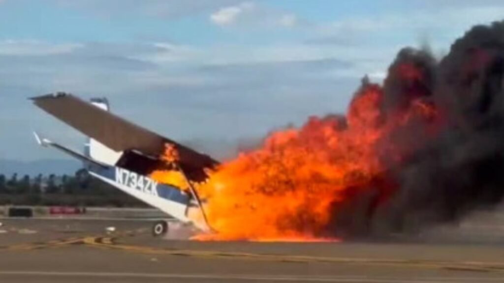 Two Killed As Cessna 172 Crashes And Erupts In Flames At San Diego Airport SEO DES: The aircraft was conducting touch-and-go approaches before crashing on its ninth go-around amid winds of 17 knots, gusting to 22 knots SOCIAL: A Cessna 172N Skyhawk II, registered N734ZK, crashed and caught fire near Runway 28L at Montgomery-Gibbs Executive Airport in San Diego on September 7, 2026, killing two people. The aircraft had been conducting touch-and-go approaches before the crash. Preliminary data indicates the accident occurred during its ninth go-around amid winds of 17 knots, gusting to 22 knots. Witnesses reported a possible stall/spin, but investigators have not confirmed the cause. San Diego Fire-Rescue crews extinguished the fire and managed a fuel leak, while the NTSB and FAA began investigating. The victims’ identities have not been released, and the airport was temporarily closed following the crash. San Diego, United States: Two people were killed after a Cessna 172 crashed and erupted in flames at Montgomery-Gibbs Executive Airport in San Diego, California, during a local flight on September 7, 2026. The aircraft, identified as a 1977 Cessna 172N Skyhawk II registered N734ZK, crashed at about 5:19–5:21 p.m. local time near Runway 28L. The National Transportation Safety Board (NTSB) and Federal Aviation Administration (FAA) are investigating the accident. San Diego police confirmed two fatalities after receiving a report of the crash at about 5:21 p.m. The aircraft became engulfed in flames, prompting a major response from San Diego Fire-Rescue. Approximately 30 fire personnel responded to the runway as firefighters worked to extinguish the aircraft fire and address a small fuel leak. San Diego Fire-Rescue Assistant Fire Chief Brian Raines said rescuers initially focused on reaching the occupants but were unable to remove them because of the extent of the damage. “Rescue is always our first priority. That's what the first units were trying to do. The plane was heavily damaged, and we were not able to extricate any of the victims. We had to focus on extinguishing the fire,” Raines said. Witnesses who were working in a nearby hangar said that they heard the crash and ran toward the aircraft with fire extinguishers. Witness Mauricio Godinez said, “As soon as we got back to the plane, flames were engulfing the wings,” adding that the wings were “melting, caving in.” Another witness, identified by FOX 5/KUSI as Melissa, said, “We tried our best to go save them, but it was just too much.” The aircraft was a four-seat, high-wing Cessna 172N Skyhawk II manufactured in 1977, with serial number 17269243 and a Lycoming O-320 engine. The aircraft had departed Montgomery-Gibbs earlier in the day and conducted local maneuvers before returning to the airport. It later departed again at about 4:27 p.m. and began a series of touch-and-go approaches on Runway 28L. The preliminary reconstruction says the accident occurred during the ninth go-around in that sequence. According to the preliminary reconstruction of ADS-B and air-traffic-control data, the Cessna was approaching Runway 28L while aircraft were also operating on the parallel Runway 28R. The controller provided traffic information and cleared the Cessna for the option on 28L. The pilot acknowledged the traffic and subsequently announced a go-around. ATC instructed the aircraft to extend upwind and issued additional traffic information as the Cessna maneuvered in the airport traffic pattern. The controller later warned that the Cessna was drifting north while another aircraft was departing westbound. The pilot responded that the aircraft was correcting south. ATC then provided further instructions for the crosswind turn and continued issuing traffic information. The pilot acknowledged the traffic. Shortly afterward, the controller reported winds of approximately 310 degrees at 17 knots, gusting to 22 knots. The Cessna then announced another go-around. According to the preliminary account, approximately four seconds later an impact sound was heard. The controller immediately informed another aircraft that the Cessna had experienced an accident and said the airport would be closed. A final transmission was subsequently heard from the accident aircraft before communications ended. Witness information cited in the preliminary aviation reconstruction indicates the aircraft may have entered a stall/spin during the attempted go-around before striking the ground near the holding point for Runway 28L. However, investigators have not determined that a stall or spin caused the accident, and no probable cause has been established. The NTSB investigation remains ongoing. The aircraft came to rest upright near the holding point for Runway 28L and was consumed by a post-crash fire. Preliminary photographs and observations indicate the cabin was heavily damaged by the fire, while the wings and tail remained attached to the aircraft. The available preliminary reconstruction says there was little evidence of a substantial debris field before the main wreckage. The identities of the two people killed have not been released by authorities. Investigators had not initially confirmed whether the pilot was experienced or whether the flight was being conducted as a training operation. The airport was temporarily closed following the crash while emergency crews handled the wreckage and fuel leak. The main runway later reopened after the emergency response and initial scene work. The NTSB will examine the aircraft, flight-track data, air-traffic-control communications, weather, pilot qualifications, maintenance records and other evidence to determine what led to the fatal crash.