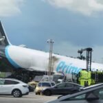 Amazon Air 767 Crew Warned Of Excessive Speed Before Miami Runway Overrun, NTSB Reveals SEO DES: The Sept 6 crash killed 5 airport cleaning workers on ground, injured 5 others, while both pilots survived; NTSB continues its examination of the crash SOCIAL: One of the pilots of Amazon Prime Air Flight 7598 repeatedly warned that the Boeing 767 was travelling too fast during its final approach to Miami International Airport, according to newly released NTSB cockpit recorder information. The recording captured repeated concerns about excessive speed, followed by “sink rate” and “too low terrain” warnings before the aircraft touched down on Runway 30. Flight data showed the aircraft touched down at a groundspeed of 158 knots before the crew briefly initiated a go-around. The throttles were increased to go-around thrust but were reduced to idle four seconds later, with the brakes reapplied. The NTSB found no indication that the speed brakes or thrust reversers were deployed before the aircraft left the paved surface, travelled about 1,300 feet beyond the runway and struck vehicles. The September 6, 2026 crash killed five airport cleaning workers, while five other people were injured and both pilots survived. The NTSB has interviewed the flight crew and continues examining the approach, automated warnings, attempted go-around, runway excursion and other factors. Investigators have not yet determined the probable cause. Miami, United States: One of the pilots of Amazon Prime Air Flight 7598 repeatedly warned that the Boeing 767 was travelling too fast during its final approach to Miami International Airport, according to newly released cockpit recorder information from the US National Transportation Safety Board (NTSB). The NTSB said that about one minute and 42 seconds before the cockpit voice recorder ended, one pilot called for the flaps to be set to 20 degrees while the other cautioned that the aircraft was “too fast.” The pilot continued making comments about the aircraft's excessive speed throughout the remainder of the recording, but investigators said there was no consistent verbal response to those concerns. The newly released preliminary evidence provides the clearest account yet of the final moments before the cargo aircraft overran Runway 30 on September 6, 2026, struck vehicles beyond the airport and killed five people on the ground. The Boeing 767-33A, operated by 21 Air as Amazon Prime Air Flight 7598, had arrived from San Juan, Puerto Rico, on its third flight of the day. Only the two pilots were onboard the aircraft. The NTSB recovered both the cockpit voice recorder and flight data recorder and successfully read them at its laboratory in Washington. The cockpit recorder contained more than two hours of good-quality audio across four channels, while the flight recorder contained about 54 hours of information covering more than 400 parameters. According to the preliminary timeline, the crew was cleared to land on Runway 30 about four minutes before the recording ended. The landing gear was lowered, and the crew progressively selected additional flap settings. About 1 minute and 23 seconds before the end of the recording, sounds consistent with the autopilot disconnect were captured. The aircraft then descended amid a series of automated warnings. The cockpit recorded two “sink rate” warnings, followed by the electronic 500-foot, 100-foot and minimums callouts. About 48 seconds before the recording ended, the automated “too low terrain” warning sounded four times, followed by another such warning seconds later. Sounds consistent with touchdown were recorded about 31 seconds before the end of the cockpit recording. Flight data showed the aircraft's nose and right main landing gear touched down at a groundspeed of 158 knots. The brakes were applied as the aircraft slowed to 146 knots, while the left main gear touched down at 134 knots. About 15 seconds before the end of the recording, a pilot called for a go-around. At the same time, the brakes were released at a groundspeed of 120 knots and the throttles were increased to a setting consistent with go-around thrust. However, four seconds later, the throttles were reduced to idle and the brakes were reapplied while the aircraft was still travelling at 117 knots. About seven seconds before the flight recorder ended, the recorded acceleration values changed markedly. The aircraft subsequently left the paved surface, according to the preliminary data. The NTSB said the final recorded groundspeed was 65 knots and found no indication in the recorded data that either the speed brakes or thrust reversers were deployed. The aircraft travelled about 1,300 feet beyond the runway, struck a van carrying airport cleaning workers, continued through the airport perimeter area and later struck a Toyota Corolla Cross before catching fire. The NTSB stressed that all recorder information released so far is preliminary and subject to change. It has not yet determined the probable cause of the accident. The confirmed death toll remains five, according to the latest available information from Miami-Dade authorities. All five people killed were occupants of the van struck by the Boeing 767. The victims were identified as, Rolando Aleman Leon, 55; Yoel Rodriguez Naranjo, 53; Julio C. Pineda, 75; Carlos Acosta Fajardo, 53 and Javierkys Reyes Quevedo, 47. They were employees of Professional Ocean Service Corp., an aircraft-cleaning contractor at Miami International Airport. Reports said the workers were finishing their shift when the crash occurred. Five other people were injured in the accident. The two pilots survived and were released from hospital. The latest local authority updates reported that two other injured people remained in critical condition, while another was in stable condition. NTSB investigators have interviewed the captain and first officer and will conduct a detailed review of the cockpit recording before producing a written transcript. The investigation is continuing into the circumstances surrounding the approach and landing, including the aircraft's speed, the automated cockpit warnings, the attempted go-around and why the speed brakes and thrust reversers were not indicated as deployed in the recorded data. Investigators are also examining the broader circumstances surrounding the runway excursion, including weather and runway safety factors. The NTSB has previously said it will review whether the absence of an Engineered Materials Arresting System (EMAS) at the runway end was relevant, although Miami International Airport met applicable FAA runway safety requirements. The final NTSB report, which will determine the probable cause and issue any safety recommendations, is expected to take considerably longer. For now, the investigation remains ongoing.