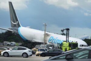 Amazon Air 767 Crew Warned Of Excessive Speed Before Miami Runway Overrun, NTSB Reveals SEO DES: The Sept 6 crash killed 5 airport cleaning workers on ground, injured 5 others, while both pilots survived; NTSB continues its examination of the crash SOCIAL: One of the pilots of Amazon Prime Air Flight 7598 repeatedly warned that the Boeing 767 was travelling too fast during its final approach to Miami International Airport, according to newly released NTSB cockpit recorder information. The recording captured repeated concerns about excessive speed, followed by “sink rate” and “too low terrain” warnings before the aircraft touched down on Runway 30. Flight data showed the aircraft touched down at a groundspeed of 158 knots before the crew briefly initiated a go-around. The throttles were increased to go-around thrust but were reduced to idle four seconds later, with the brakes reapplied. The NTSB found no indication that the speed brakes or thrust reversers were deployed before the aircraft left the paved surface, travelled about 1,300 feet beyond the runway and struck vehicles. The September 6, 2026 crash killed five airport cleaning workers, while five other people were injured and both pilots survived. The NTSB has interviewed the flight crew and continues examining the approach, automated warnings, attempted go-around, runway excursion and other factors. Investigators have not yet determined the probable cause. Miami, United States: One of the pilots of Amazon Prime Air Flight 7598 repeatedly warned that the Boeing 767 was travelling too fast during its final approach to Miami International Airport, according to newly released cockpit recorder information from the US National Transportation Safety Board (NTSB). The NTSB said that about one minute and 42 seconds before the cockpit voice recorder ended, one pilot called for the flaps to be set to 20 degrees while the other cautioned that the aircraft was “too fast.” The pilot continued making comments about the aircraft's excessive speed throughout the remainder of the recording, but investigators said there was no consistent verbal response to those concerns. The newly released preliminary evidence provides the clearest account yet of the final moments before the cargo aircraft overran Runway 30 on September 6, 2026, struck vehicles beyond the airport and killed five people on the ground. The Boeing 767-33A, operated by 21 Air as Amazon Prime Air Flight 7598, had arrived from San Juan, Puerto Rico, on its third flight of the day. Only the two pilots were onboard the aircraft. The NTSB recovered both the cockpit voice recorder and flight data recorder and successfully read them at its laboratory in Washington. The cockpit recorder contained more than two hours of good-quality audio across four channels, while the flight recorder contained about 54 hours of information covering more than 400 parameters. According to the preliminary timeline, the crew was cleared to land on Runway 30 about four minutes before the recording ended. The landing gear was lowered, and the crew progressively selected additional flap settings. About 1 minute and 23 seconds before the end of the recording, sounds consistent with the autopilot disconnect were captured. The aircraft then descended amid a series of automated warnings. The cockpit recorded two “sink rate” warnings, followed by the electronic 500-foot, 100-foot and minimums callouts. About 48 seconds before the recording ended, the automated “too low terrain” warning sounded four times, followed by another such warning seconds later. Sounds consistent with touchdown were recorded about 31 seconds before the end of the cockpit recording. Flight data showed the aircraft's nose and right main landing gear touched down at a groundspeed of 158 knots. The brakes were applied as the aircraft slowed to 146 knots, while the left main gear touched down at 134 knots. About 15 seconds before the end of the recording, a pilot called for a go-around. At the same time, the brakes were released at a groundspeed of 120 knots and the throttles were increased to a setting consistent with go-around thrust. However, four seconds later, the throttles were reduced to idle and the brakes were reapplied while the aircraft was still travelling at 117 knots. About seven seconds before the flight recorder ended, the recorded acceleration values changed markedly. The aircraft subsequently left the paved surface, according to the preliminary data. The NTSB said the final recorded groundspeed was 65 knots and found no indication in the recorded data that either the speed brakes or thrust reversers were deployed. The aircraft travelled about 1,300 feet beyond the runway, struck a van carrying airport cleaning workers, continued through the airport perimeter area and later struck a Toyota Corolla Cross before catching fire. The NTSB stressed that all recorder information released so far is preliminary and subject to change. It has not yet determined the probable cause of the accident. The confirmed death toll remains five, according to the latest available information from Miami-Dade authorities. All five people killed were occupants of the van struck by the Boeing 767. The victims were identified as, Rolando Aleman Leon, 55; Yoel Rodriguez Naranjo, 53; Julio C. Pineda, 75; Carlos Acosta Fajardo, 53 and Javierkys Reyes Quevedo, 47. They were employees of Professional Ocean Service Corp., an aircraft-cleaning contractor at Miami International Airport. Reports said the workers were finishing their shift when the crash occurred. Five other people were injured in the accident. The two pilots survived and were released from hospital. The latest local authority updates reported that two other injured people remained in critical condition, while another was in stable condition. NTSB investigators have interviewed the captain and first officer and will conduct a detailed review of the cockpit recording before producing a written transcript. The investigation is continuing into the circumstances surrounding the approach and landing, including the aircraft's speed, the automated cockpit warnings, the attempted go-around and why the speed brakes and thrust reversers were not indicated as deployed in the recorded data. Investigators are also examining the broader circumstances surrounding the runway excursion, including weather and runway safety factors. The NTSB has previously said it will review whether the absence of an Engineered Materials Arresting System (EMAS) at the runway end was relevant, although Miami International Airport met applicable FAA runway safety requirements. The final NTSB report, which will determine the probable cause and issue any safety recommendations, is expected to take considerably longer. For now, the investigation remains ongoing.