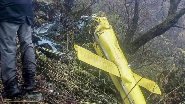 Joshimath, India: Six people, including the pilot, were killed after a helicopter crashed in the forested mountainous region near Chai village in Joshimath, Chamoli district, Uttarakhand, on Friday, October 30, 2026. The helicopter was flying from Badrinath to the Sahastradhara helipad in Dehradun with one pilot and five passengers when it crashed. The Ministry of Civil Aviation confirmed the accident in a statement issued through the Press Information Bureau (PIB) at 9:11 PM on Friday. According to the ministry, the helicopter operated by Trans Bharat Aviation, departed from Badrinath helipad at 1:14 PM and was en route to Sahastradhara helipad when the accident occurred. The ministry identified the crash location as the forest area near Chai village in Joshimath. The Ministry of Civil Aviation did not specify whether the service was a charter, scheduled passenger service or pilgrimage flight. Uttarakhand Civil Aviation Development Authority (UCADA) CEO Prateek Jain confirmed that all six occupants, including the pilot, had died. Chamoli District Magistrate Gaurav Kumar also confirmed the fatalities. The deceased included pilot Captain Himanshu Sabharwal, a resident of Delhi, and five passengers from Karnataka: Arun Salunke, Prathapa Bachihally Ningaraju, Shankar Gowda VB, Sudheer K and H.S. Nataraju. Karnataka Home Minister Priyank Kharge identified Arun Salunke as an inspector with the Bengaluru Police Central Crime Branch (CCB). The Karnataka government subsequently confirmed that the mortal remains of all six occupants had been recovered. According to UCADA, the helicopter lost communication while flying over the Joshimath valley, after which its tracking system also stopped receiving location information. The authority stated, "The helicopter lost communication while it was flying over Joshimath valley. At the same time, the tracking system could no longer track the helicopter." Chamoli Superintendent of Police Surjeet Singh Panwar said the aircraft's radar transmission link was lost near Joshimath approximately two minutes after its departure from Badrinath. Uttarakhand Secretary for Disaster Management and Rehabilitation Vinod Kumar Suman said the Chamoli District Disaster Management Officer informed the authorities at around 2 PM that a civilian helicopter had met with an accident. An Army Signal Centre team subsequently spotted smoke rising from the helicopter and observed it descending rapidly, prompting a coordinated search and rescue response. The Chamoli district administration, Indian Army, State Disaster Response Force (SDRF), Indo-Tibetan Border Police (ITBP), police and health department personnel were mobilised to locate the aircraft and reach the crash site. Uttarakhand Chief Minister Pushkar Singh Dhami confirmed the joint response, stating, "A joint rescue operation is being conducted by the district administration, disaster management department, and SDRF." He added, "I myself am continuously monitoring the entire incident." The Karnataka government, citing information from the Uttarakhand State Emergency Operations Centre, confirmed that rescue teams recovered the mortal remains of all six occupants. The remains were being brought to Joshimath for post-mortem examinations. The Chief Minister's Office and the Relief Commissioner of Karnataka coordinated with their Uttarakhand counterparts to facilitate the transportation of the deceased to Karnataka. Following the accident, UCADA in coordination with the Directorate General of Civil Aviation grounded the entire helicopter fleet operated by Trans Bharat Aviation Pvt Ltd as a precautionary measure. The Ministry of Civil Aviation also confirmed that a team from the Directorate General of Civil Aviation (DGCA) had been dispatched to Dehradun to conduct a preliminary and regulatory assessment of the accident. The exact cause of the crash has not yet been established. Although adverse weather conditions, including rain and reduced visibility, were reported in the region, authorities have not confirmed whether they contributed to the accident. The circumstances leading to the loss of communication and the subsequent crash remain subject to further assessment.